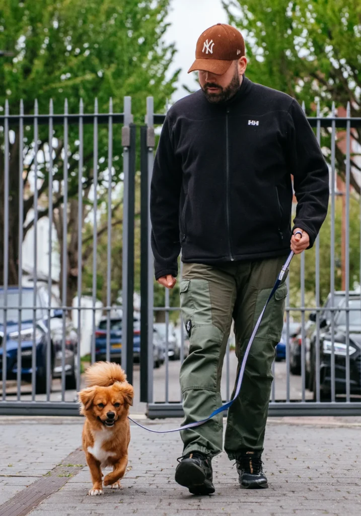 Jack teaching loose lead walking to young dog during behaviour training