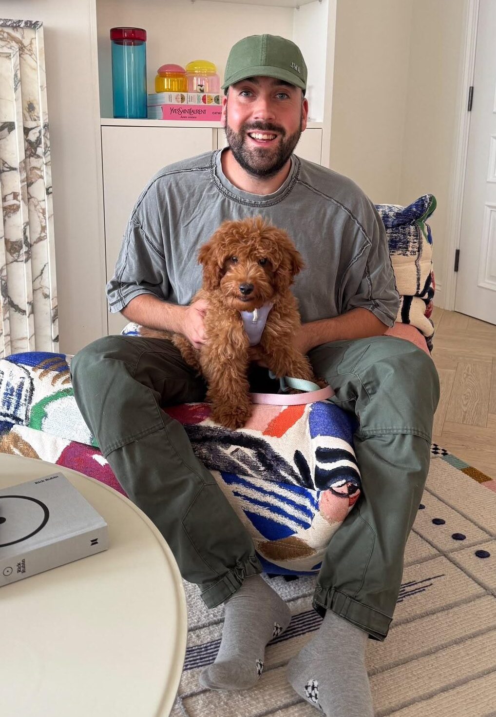 Dog behaviourist holding a young puppy during an in-home behaviour consultation in London